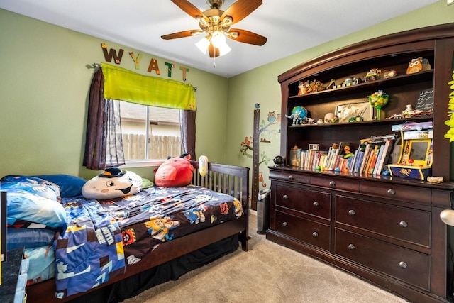 bedroom with light carpet and a ceiling fan
