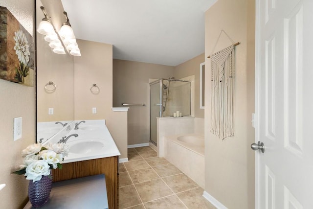 bathroom with a sink, double vanity, tile patterned floors, a shower stall, and a garden tub