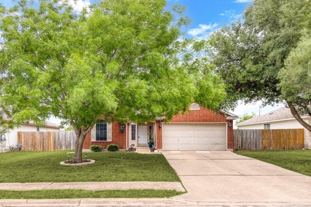 view of property hidden behind natural elements with brick siding, a garage, fence, and concrete driveway