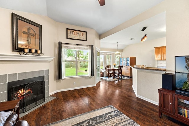 living room with baseboards, dark wood-style flooring, visible vents, and a fireplace