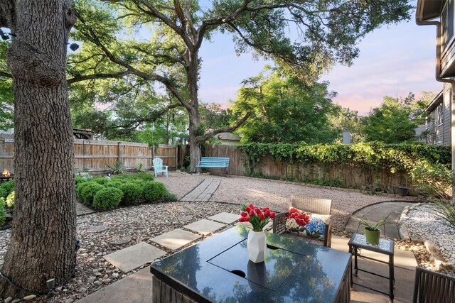 view of yard with a patio, a fenced backyard, and outdoor dining area
