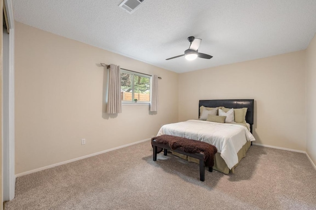 bedroom featuring baseboards, carpet, a ceiling fan, and visible vents