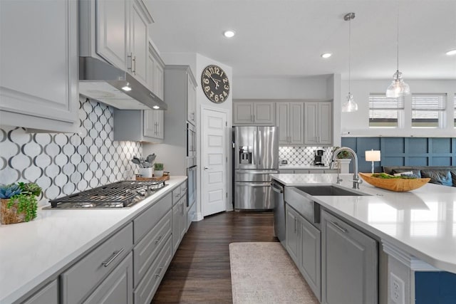 kitchen featuring a sink, light countertops, gray cabinets, stainless steel appliances, and under cabinet range hood