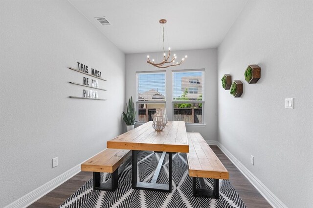 225 Palio Pl, Georgetown, TX 78628 - dining area with a chandelier, dark wood-style floors, and baseboards