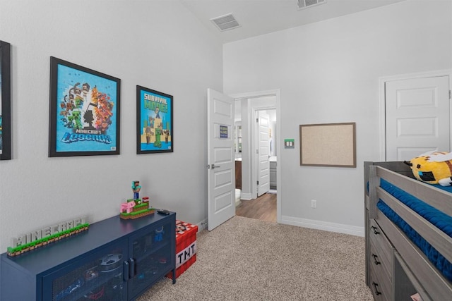 carpeted bedroom with visible vents and baseboards