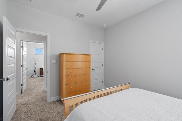 carpeted bedroom with a ceiling fan, baseboards, and visible vents
