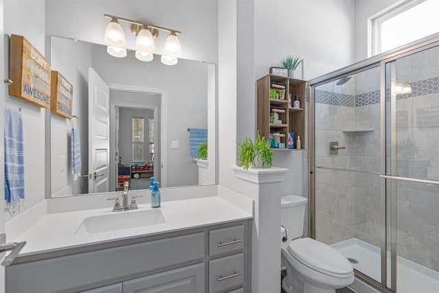 ensuite bathroom featuring vanity, toilet, connected bathroom, and a stall shower