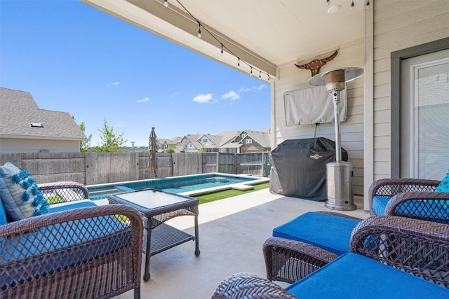 view of patio featuring grilling area, a fenced in pool, and a fenced backyard
