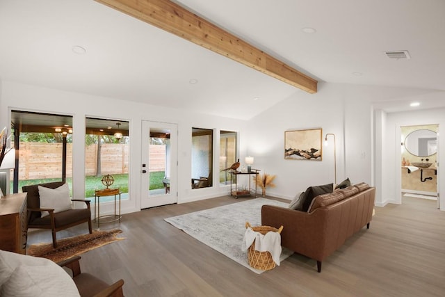 living area with baseboards, lofted ceiling with beams, wood finished floors, and recessed lighting