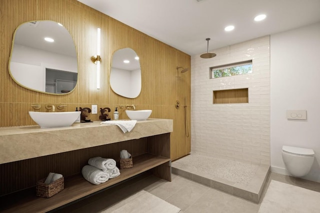 bathroom with tile patterned flooring, a sink, a walk in shower, and toilet