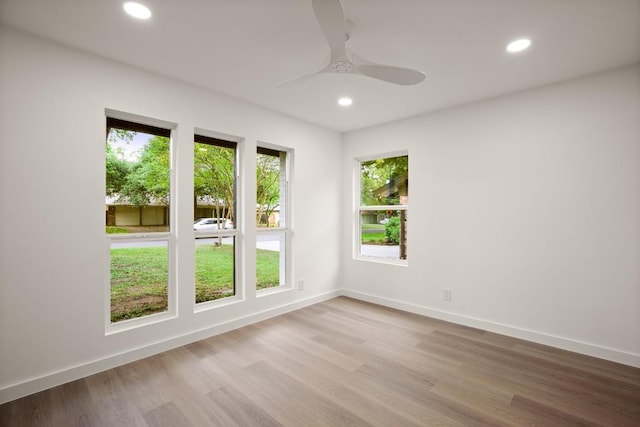 empty room featuring recessed lighting, a ceiling fan, and baseboards