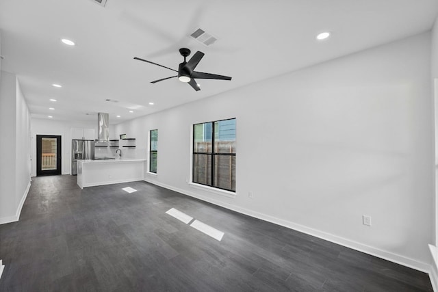 914 E 50th St, Austin, TX 78751 - unfurnished living room with recessed lighting, dark wood finished floors, baseboards, and ceiling fan