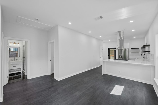 unfurnished living room with recessed lighting, attic access, dark wood-style flooring, and visible vents