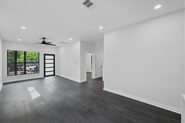 empty room with baseboards, recessed lighting, dark wood-style flooring, and visible vents