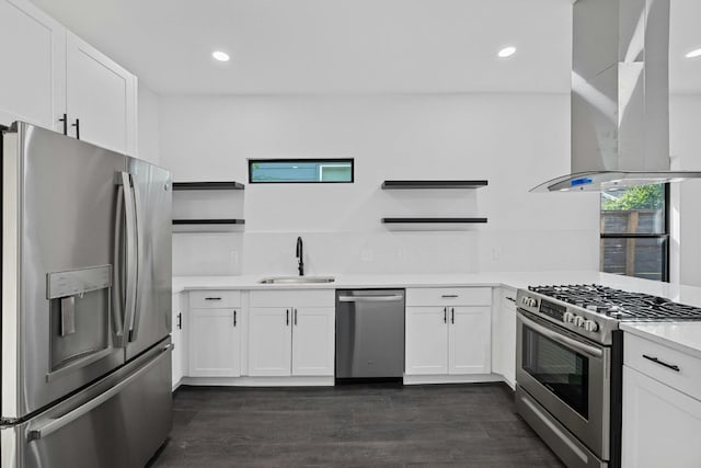 kitchen with wall chimney range hood, open shelves, a sink, stainless steel appliances, and white cabinetry