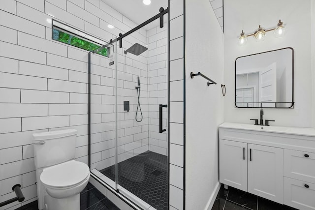 bathroom featuring toilet, a shower stall, and vanity
