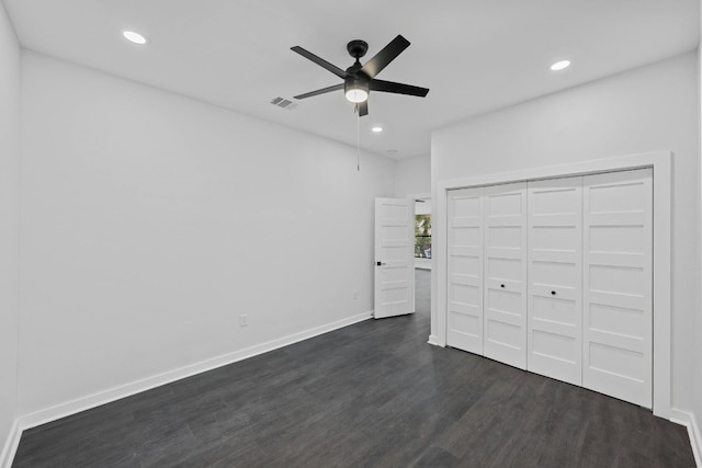 unfurnished bedroom featuring recessed lighting, baseboards, dark wood-style flooring, and visible vents