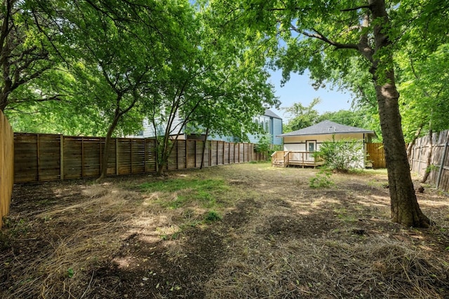 view of yard featuring a deck and a fenced backyard