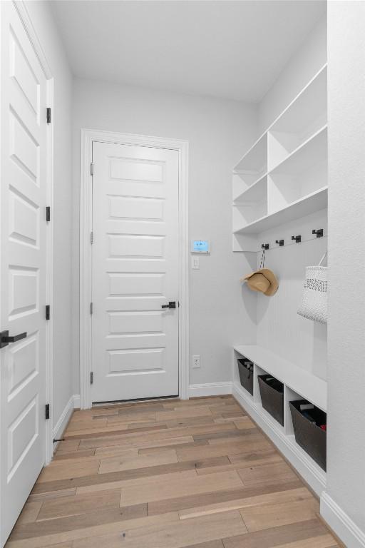 mudroom featuring baseboards and light wood-style flooring
