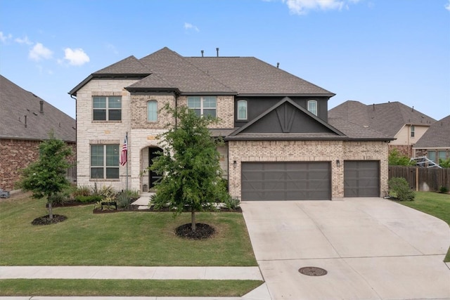 view of front of house with driveway, roof with shingles, fence, a front lawn, and an attached garage