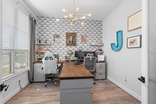 home office featuring an inviting chandelier, baseboards, and light wood-style floors