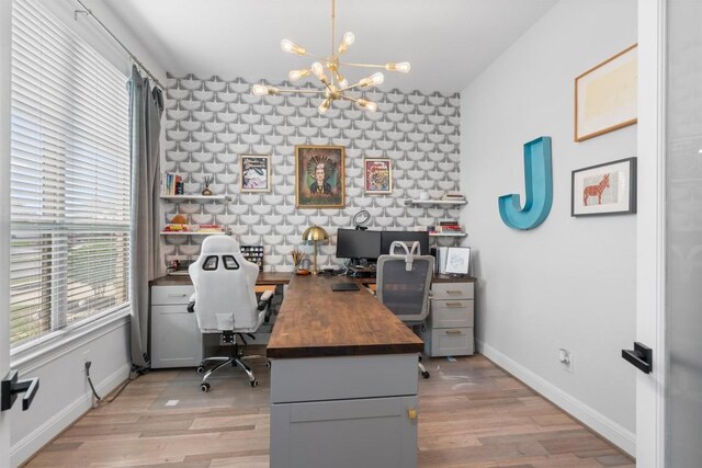 20620 Lukes Cv, Pflugerville, TX 78660 - home office featuring a chandelier, light wood finished floors, and baseboards
