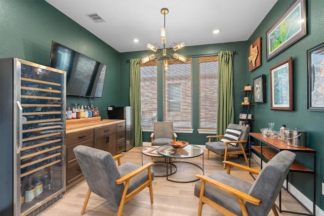 sitting room featuring visible vents, wine cooler, recessed lighting, a dry bar, and light wood-style flooring