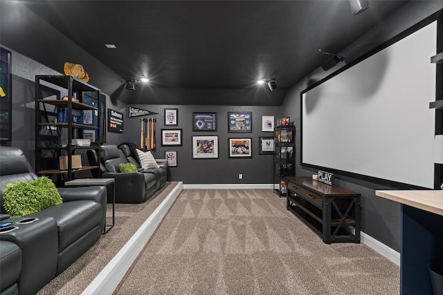 home theater room with carpet floors and baseboards