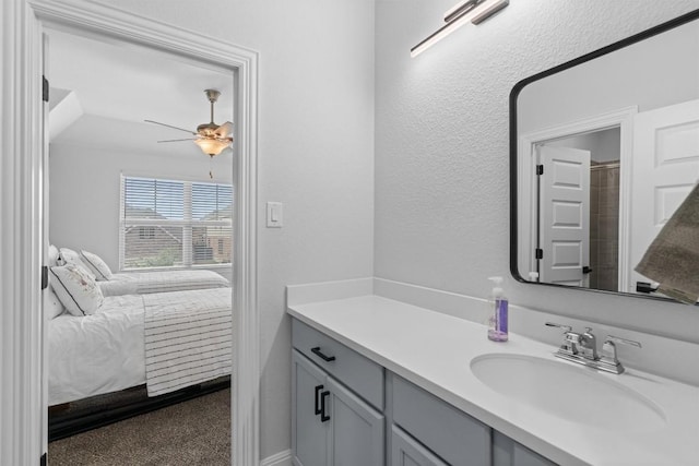 ensuite bathroom with vanity, ceiling fan, and ensuite bathroom
