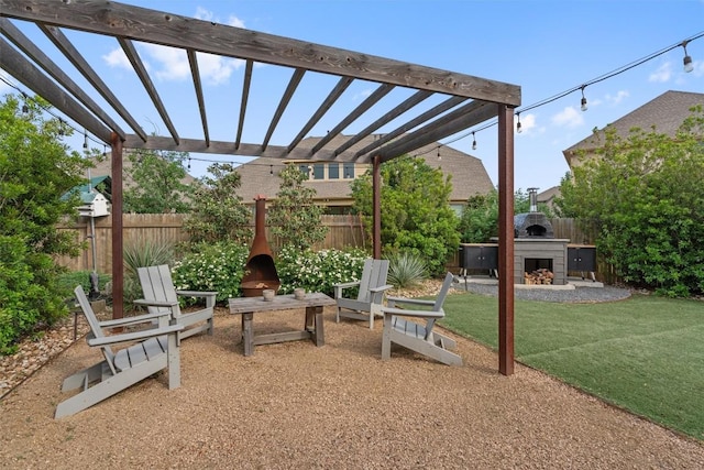 view of patio with a pergola, fence, and exterior fireplace