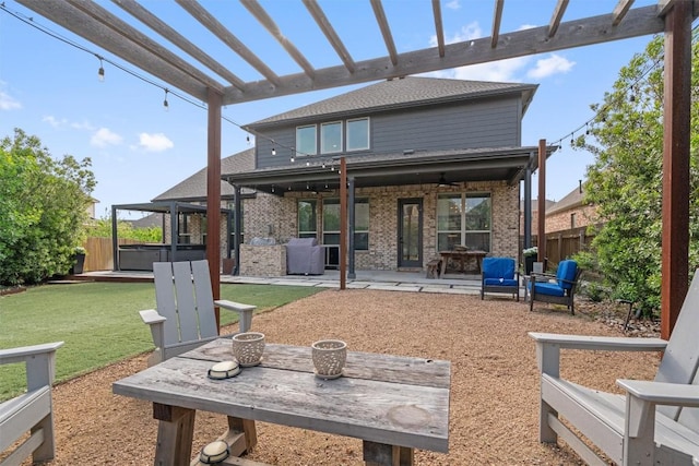 rear view of property with fence, a patio, a hot tub, and brick siding