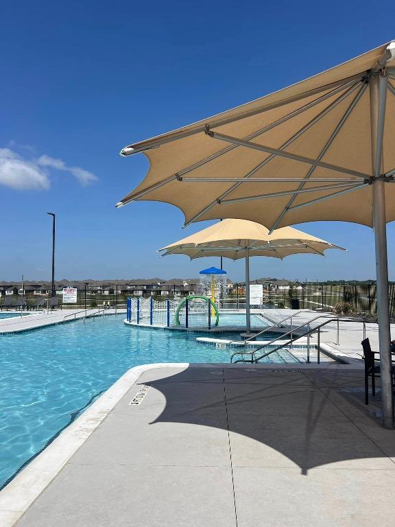 20620 Lukes Cv, Pflugerville, TX 78660 - community pool featuring a patio