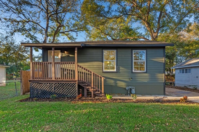 216 Armstrong St, San Marcos, TX 78666 - rear view of house featuring fence, stairs, and a yard