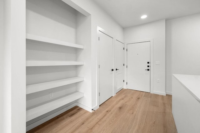 entrance foyer with light wood-style floors, baseboards, and recessed lighting