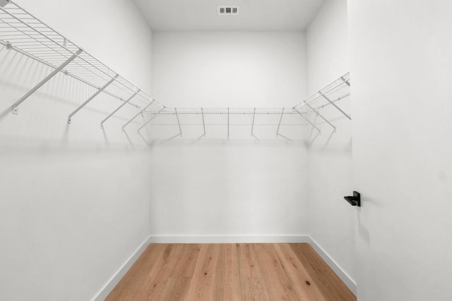 walk in closet with visible vents and light wood finished floors
