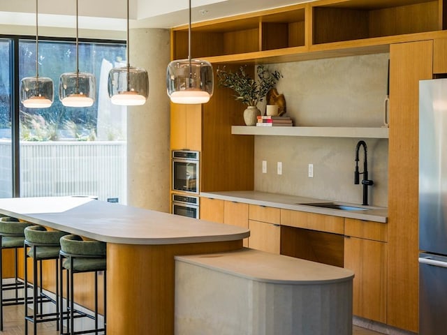 kitchen featuring open shelves, a sink, light countertops, a breakfast bar area, and modern cabinets