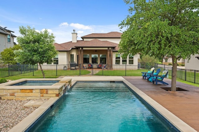 100 Red Barn Rd, Kingsland, TX 78639 - rear view of house featuring an in-ground hot tub, stucco siding, ceiling fan, and a chimney
