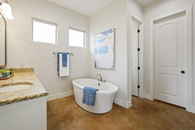 100 Red Barn Rd, Kingsland, TX 78639 - bathroom featuring concrete flooring, baseboards, a freestanding bath, and vanity
