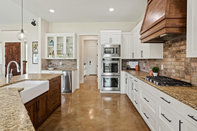 100 Red Barn Rd, Kingsland, TX 78639 - kitchen featuring a sink, premium range hood, stainless steel appliances, finished concrete flooring, and tasteful backsplash