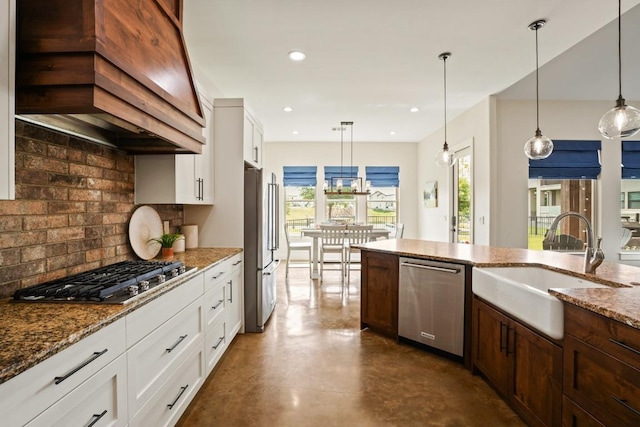 100 Red Barn Rd, Kingsland, TX 78639 - kitchen featuring appliances with stainless steel finishes, a sink, premium range hood, tasteful backsplash, and white cabinetry