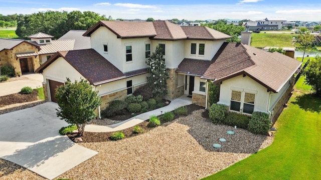 100 Red Barn Rd, Kingsland, TX 78639 - view of front of house with stucco siding, stone siding, driveway, and a shingled roof