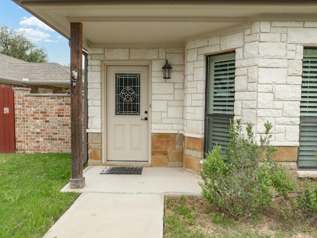 doorway to property featuring stone siding