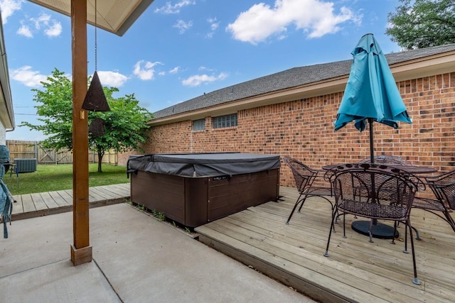 exterior space featuring outdoor dining area, a hot tub, a wooden deck, and fence