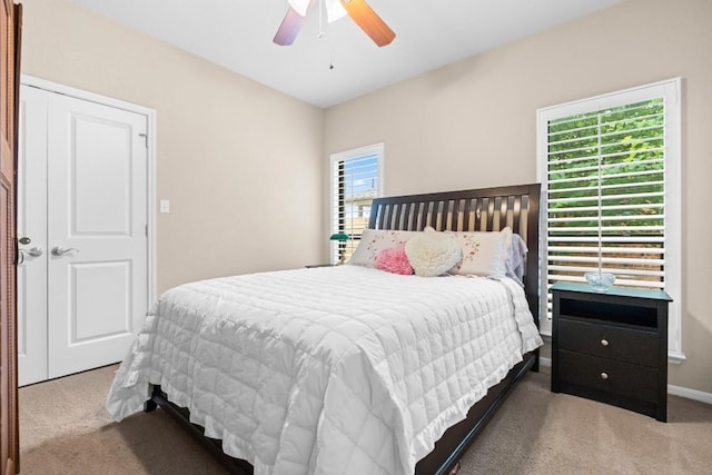 carpeted bedroom with a ceiling fan