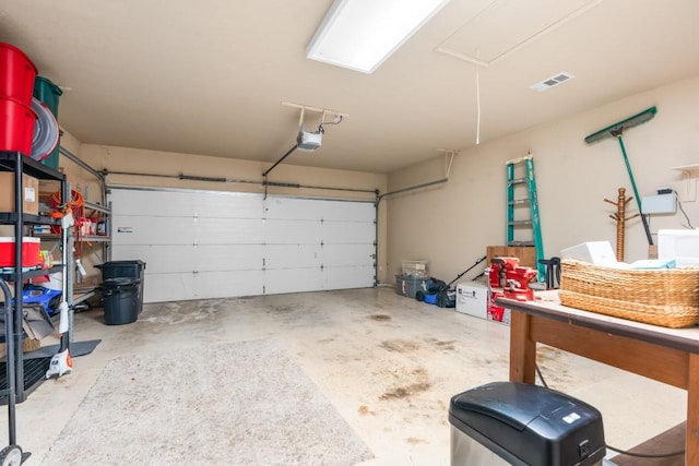 garage featuring a garage door opener and visible vents