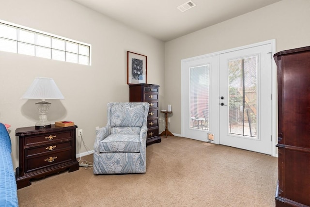 living area with visible vents, carpet, and a wealth of natural light