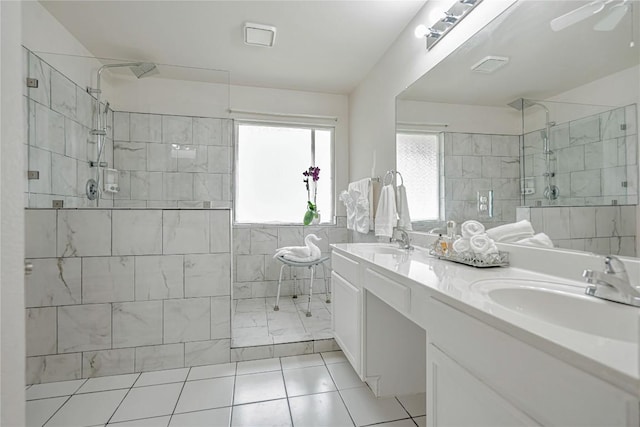 bathroom featuring a sink, tile patterned floors, a shower stall, and double vanity