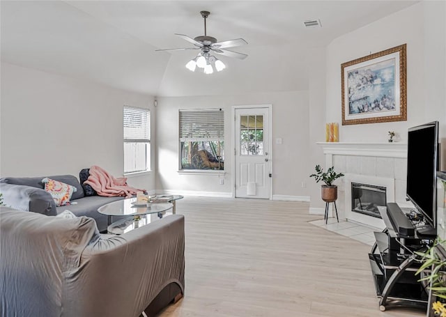 living room with light wood-style floors, ceiling fan, visible vents, and a healthy amount of sunlight