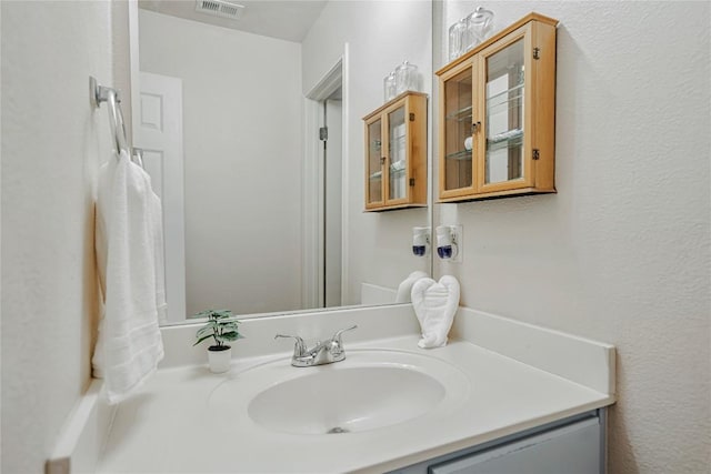 bathroom with vanity and visible vents