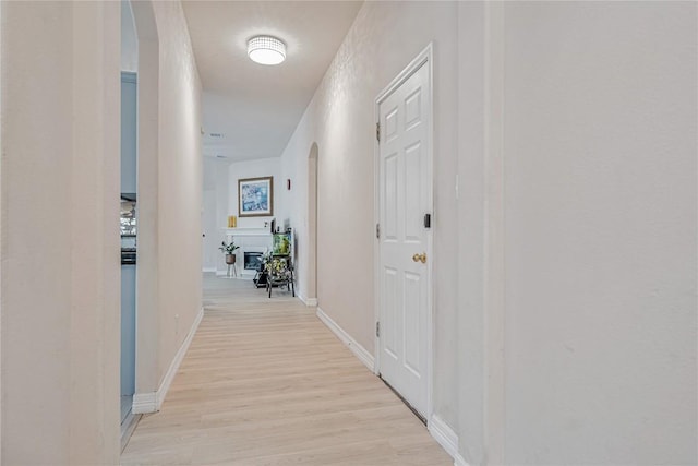 607 Columbine Ave, Cedar Park, TX 78613 - hallway featuring arched walkways, light wood-style flooring, and baseboards